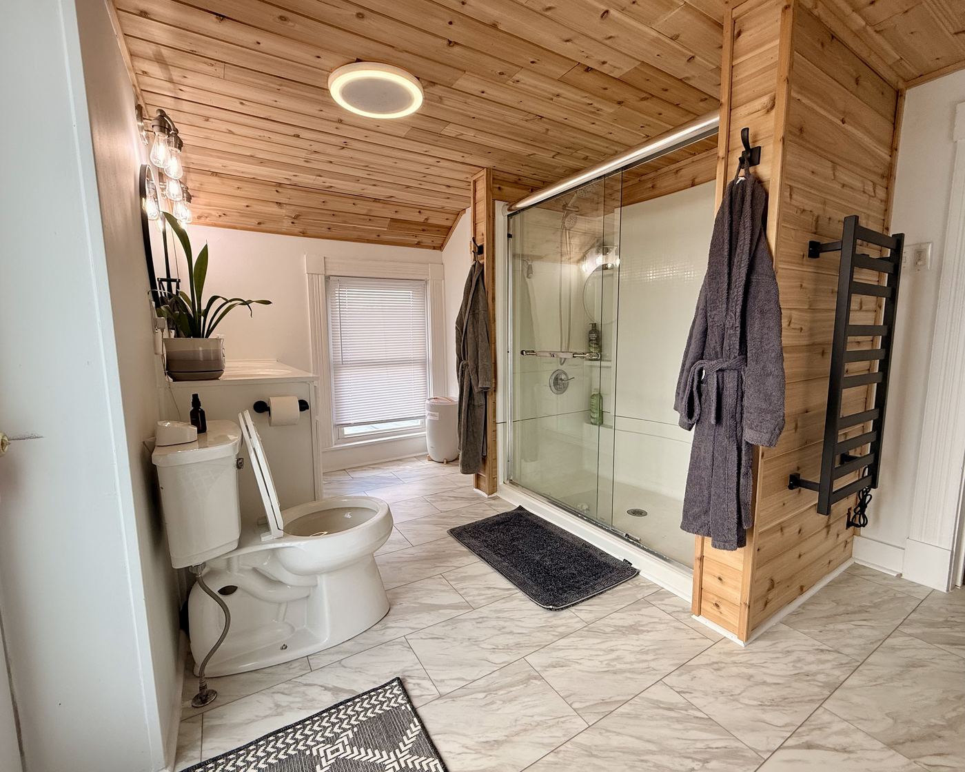 Spa-like bathroom with walk-in shower and robes